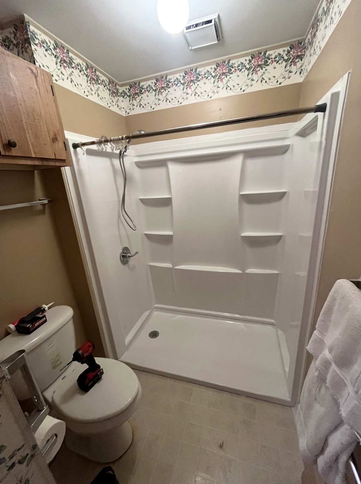 Completed white Delta walk-in shower